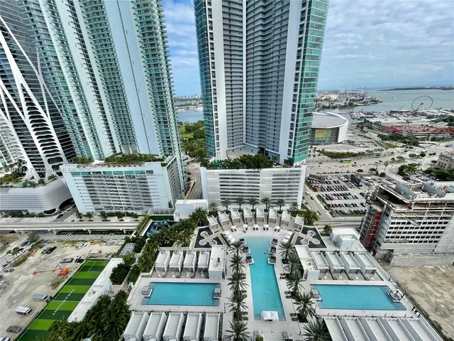 a view of roof deck with outdoor seating and city view