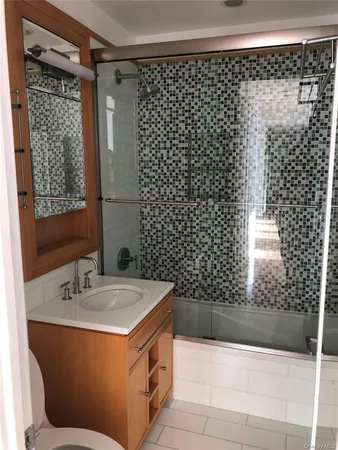 a bathroom with a bathtub and shower