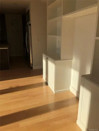a view of a room with wooden floor and a window