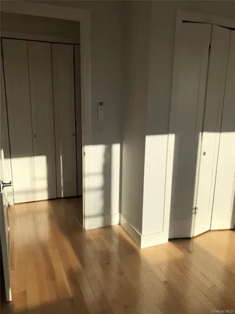 an empty room with windows and entrance