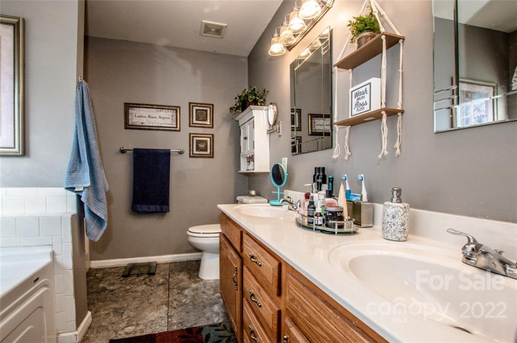 290 Wagon Wheel Way Salisbury, NC 28147 - Photo 11 of 17 a bathroom with a double vanity sink toilet and mirror