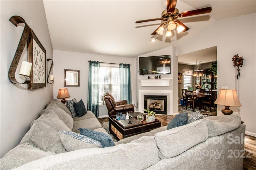 290 Wagon Wheel Way Salisbury, NC 28147 - Photo 6 of 17 a living room with furniture a fireplace and a flat screen tv