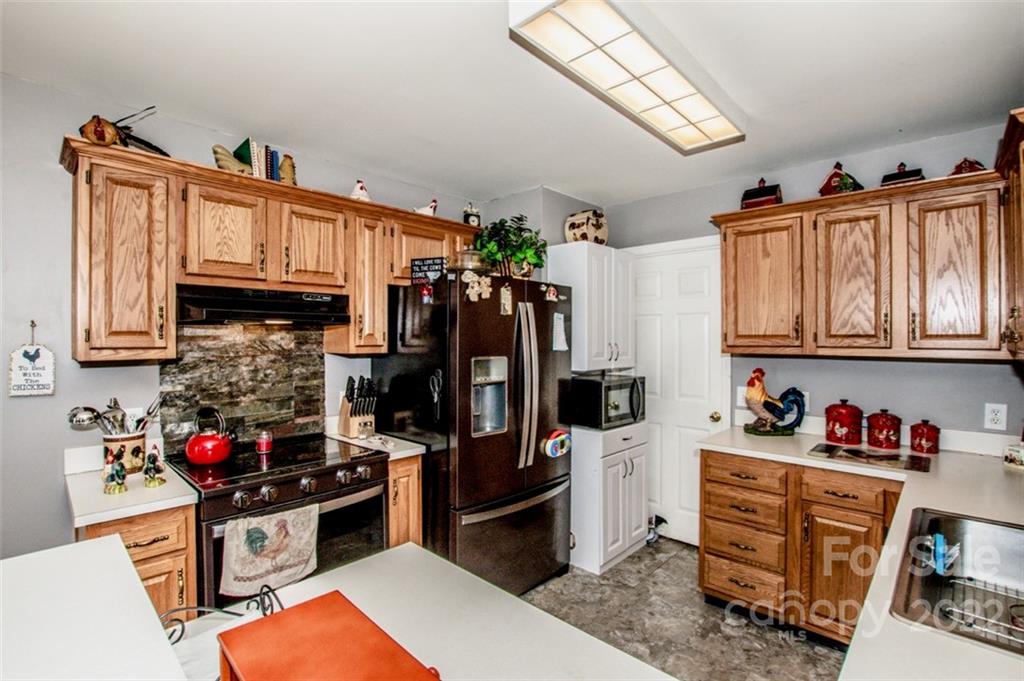 290 Wagon Wheel Way Salisbury, NC 28147 - Photo 7 of 17 a kitchen with stainless steel appliances granite countertop a refrigerator and a stove top oven