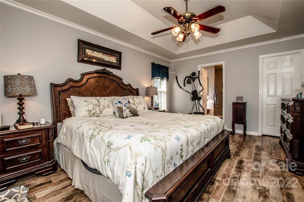 290 Wagon Wheel Way Salisbury, NC 28147 - Photo 10 of 17 a bedroom with bed and a chandelier