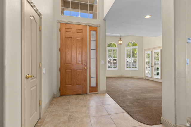 389 North Main Street St. George, UT 84770 - Photo 10 of 44 Entryway with light colored carpet, light tile patterned floors, french doors, recessed lighting, and a high ceiling