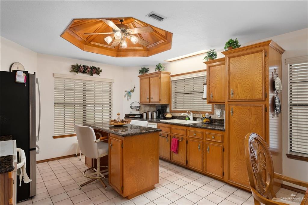 2602 Ashley Drive Pharr, TX 78577 - Photo 5 of 9 a kitchen with stainless steel appliances granite countertop a sink a stove and a refrigerator