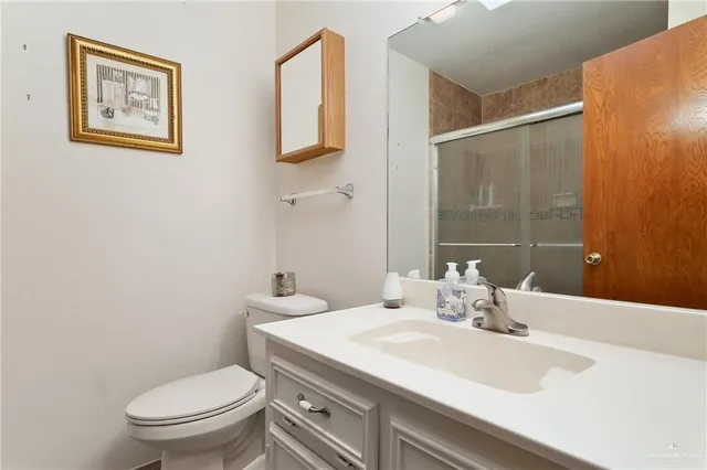 a bathroom with a sink toilet and vanity