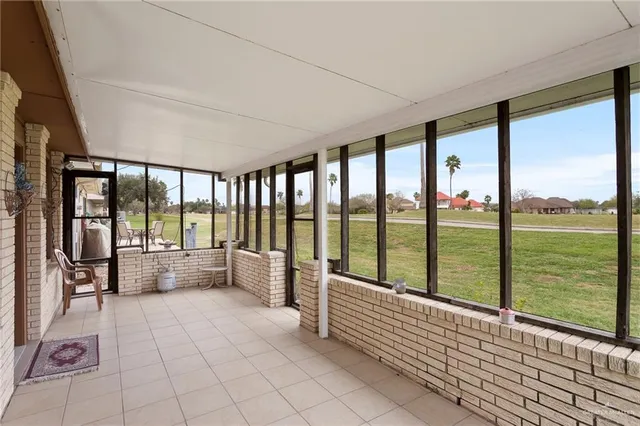 a view of an empty room with large windows