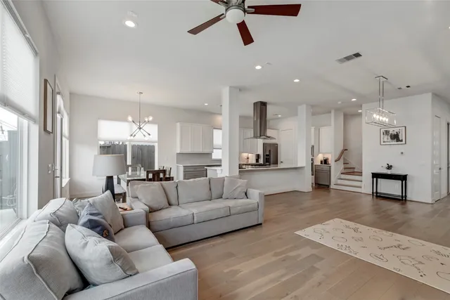 a living room with furniture and kitchen view