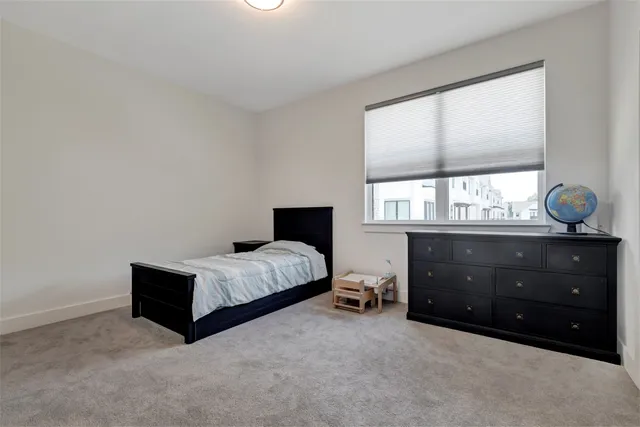 a spacious bedroom with a bed and window