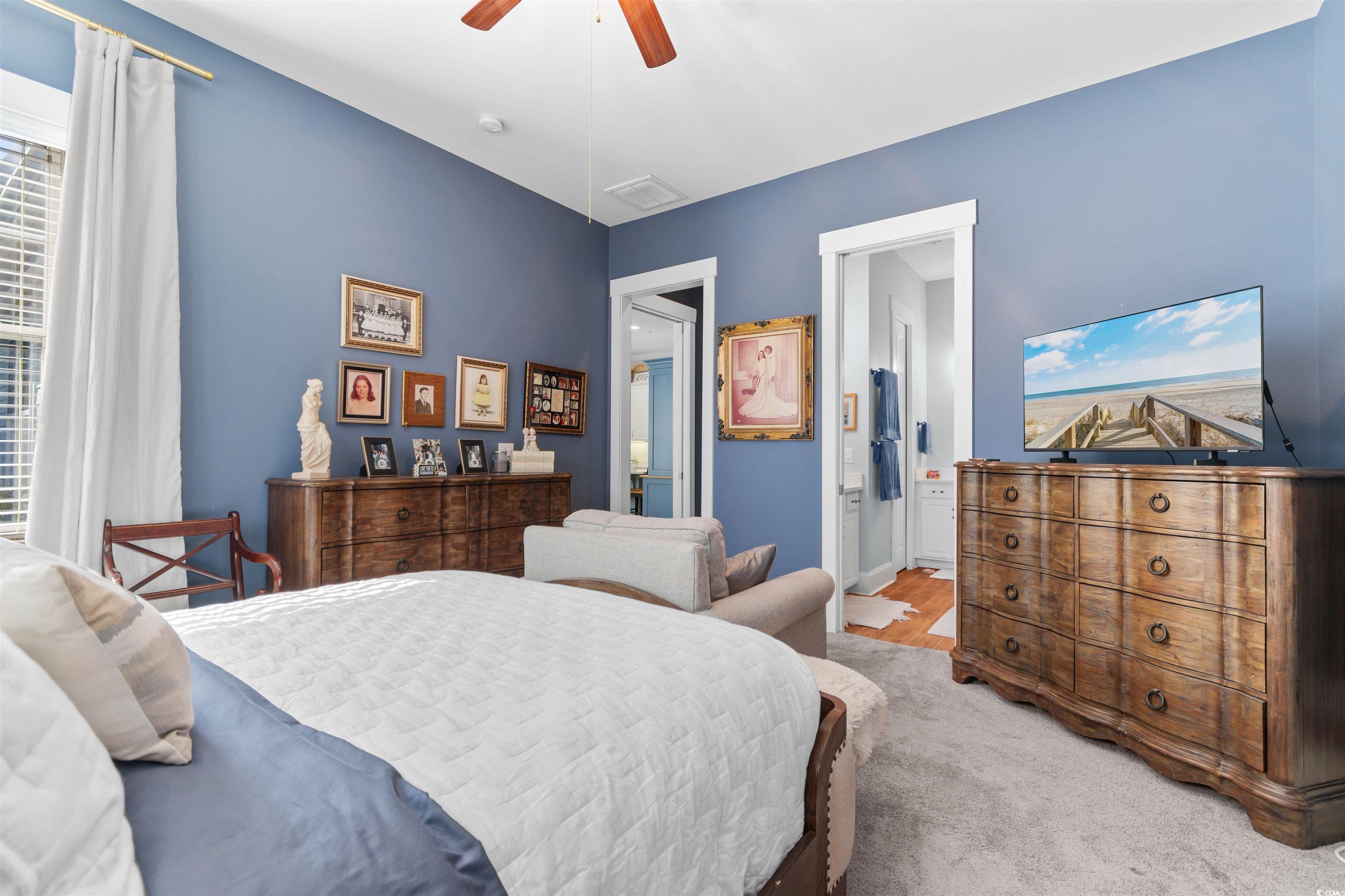 3448 Baldwin Lane Myrtle Beach, SC 29577 - Photo 11 of 30 Dining space featuring crown molding, light wood-style floors, a chandelier, beverage cooler, and a ceiling fan