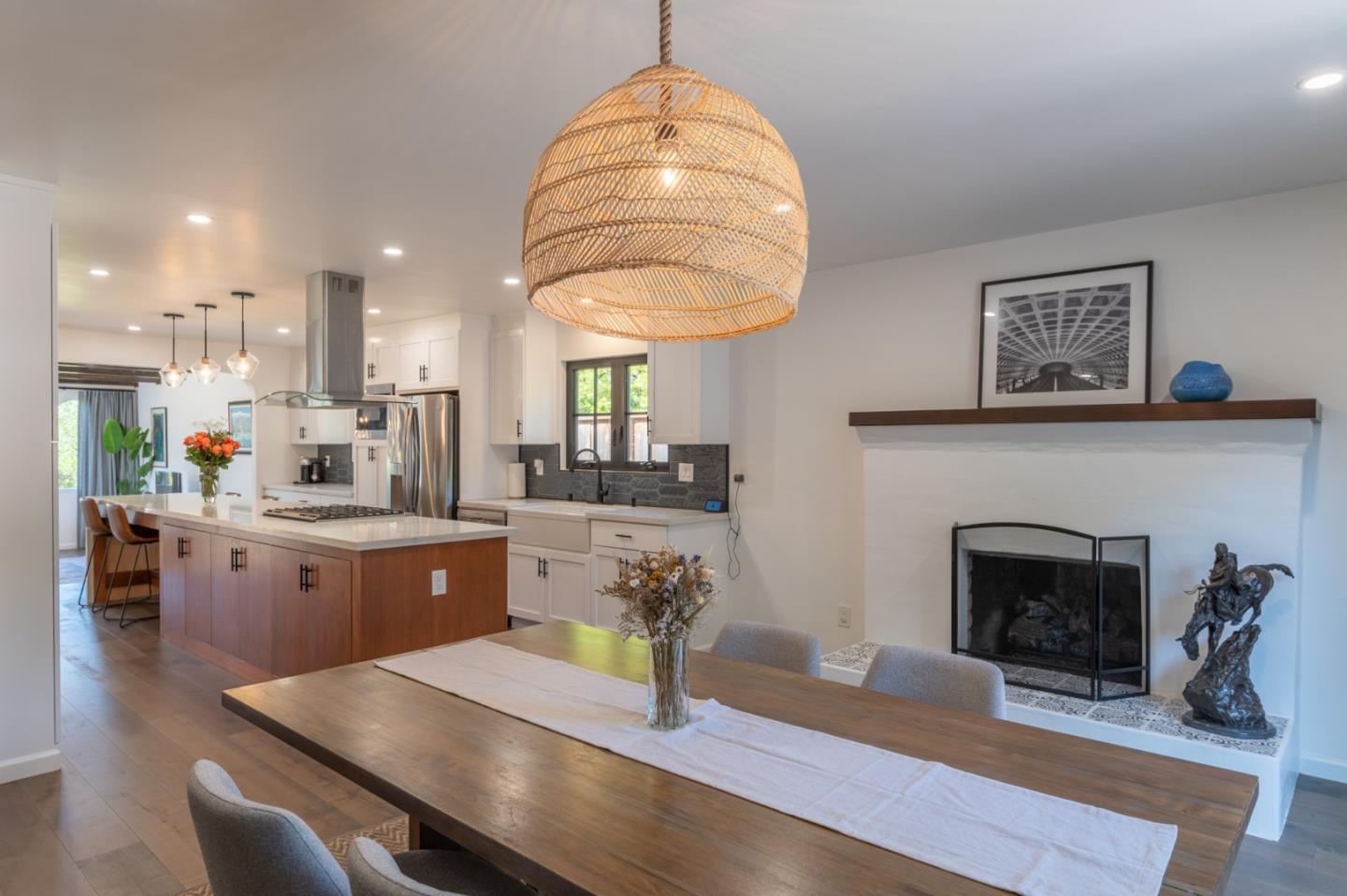 3039 Sloat Road Pebble Beach, CA 93953 - Photo 20 of 34 a living room with furniture a fireplace and kitchen view