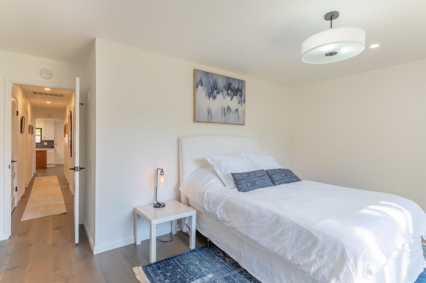 3039 Sloat Road Pebble Beach, CA 93953 - Photo 30 of 34 a bedroom with a bed and a chandelier