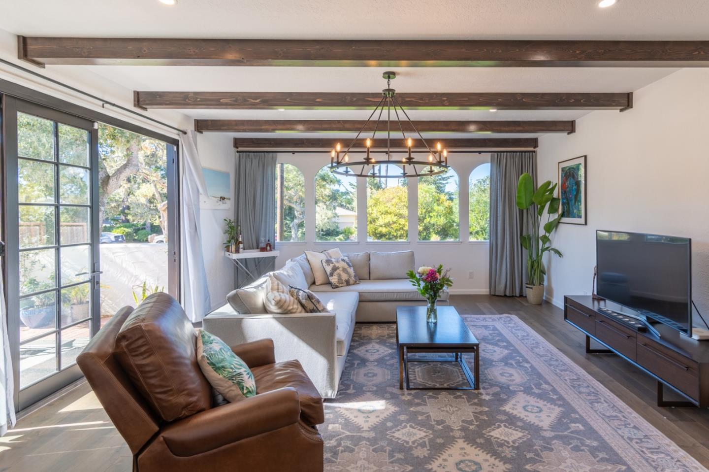 3039 Sloat Road Pebble Beach, CA 93953 - Photo 8 of 34 a living room with furniture and a flat screen tv