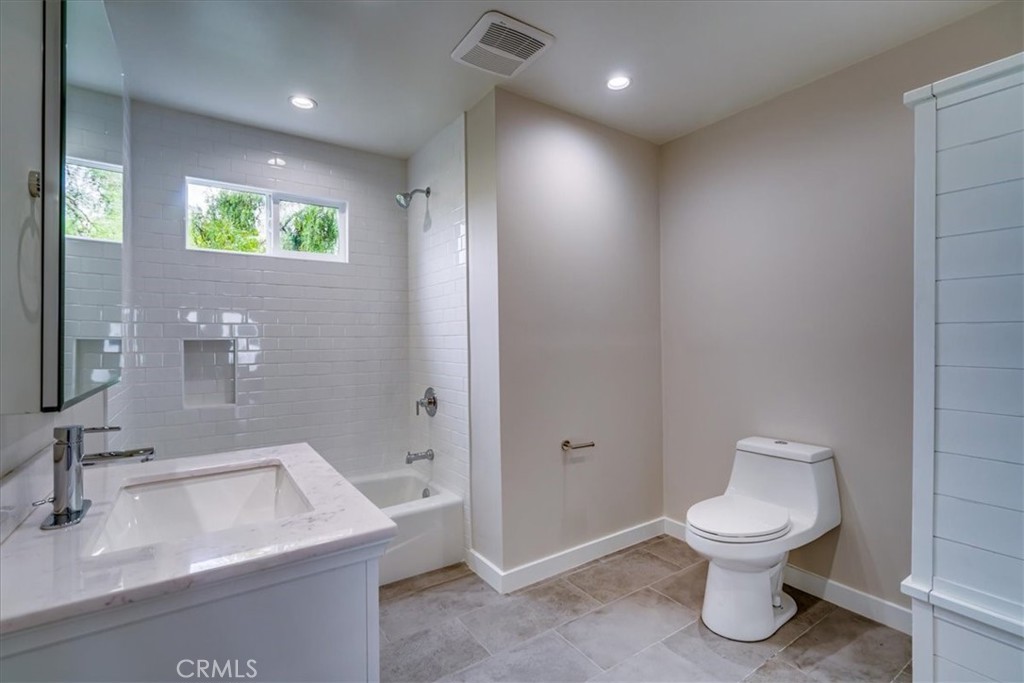 323 Culver Boulevard Playa del Rey, CA 90293 - Photo 21 of 58 a bathroom with a toilet sink and mirror