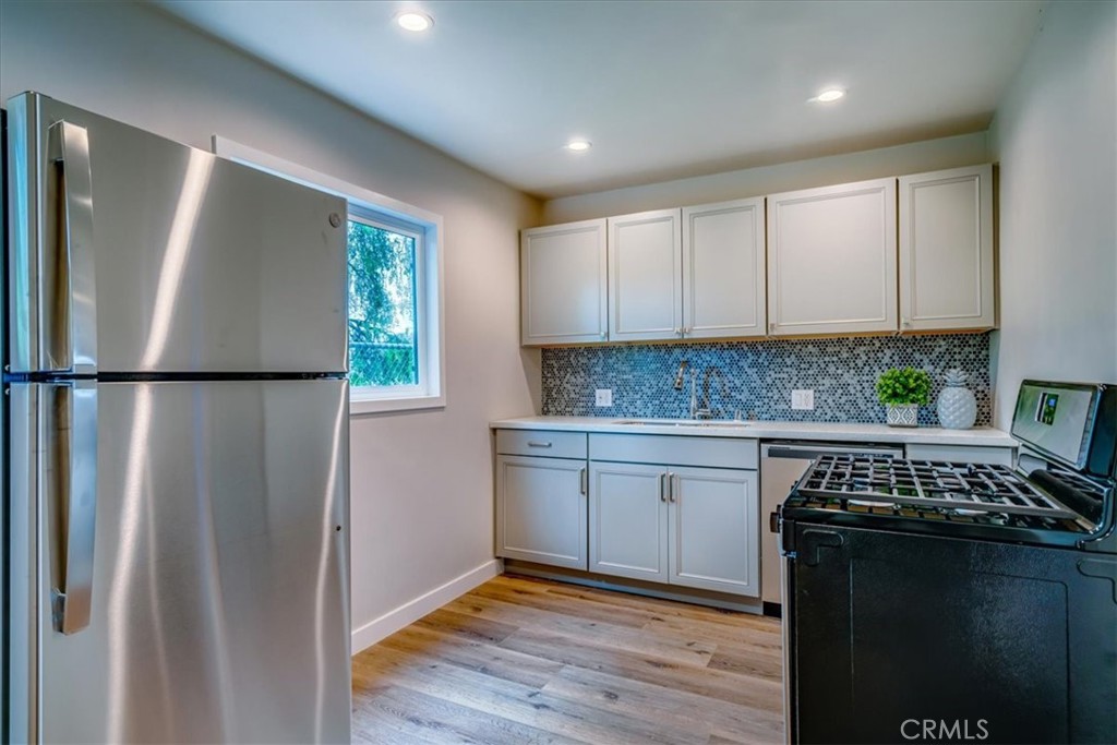 323 Culver Boulevard Playa del Rey, CA 90293 - Photo 36 of 58 a kitchen that has a lot of cabinets in it and wooden floor