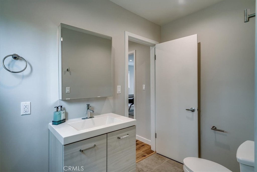 323 Culver Boulevard Playa del Rey, CA 90293 - Photo 39 of 58 a bathroom with a sink toilet and a mirror