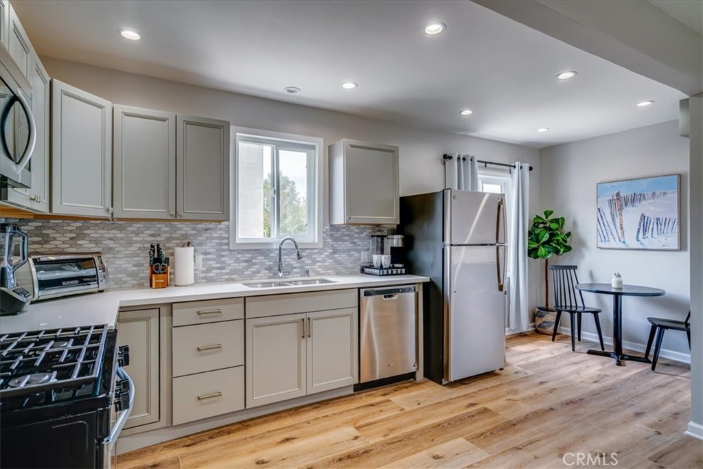323 Culver Boulevard Playa del Rey, CA 90293 - Photo 54 of 58 a kitchen with stainless steel appliances granite countertop a refrigerator and a stove top oven