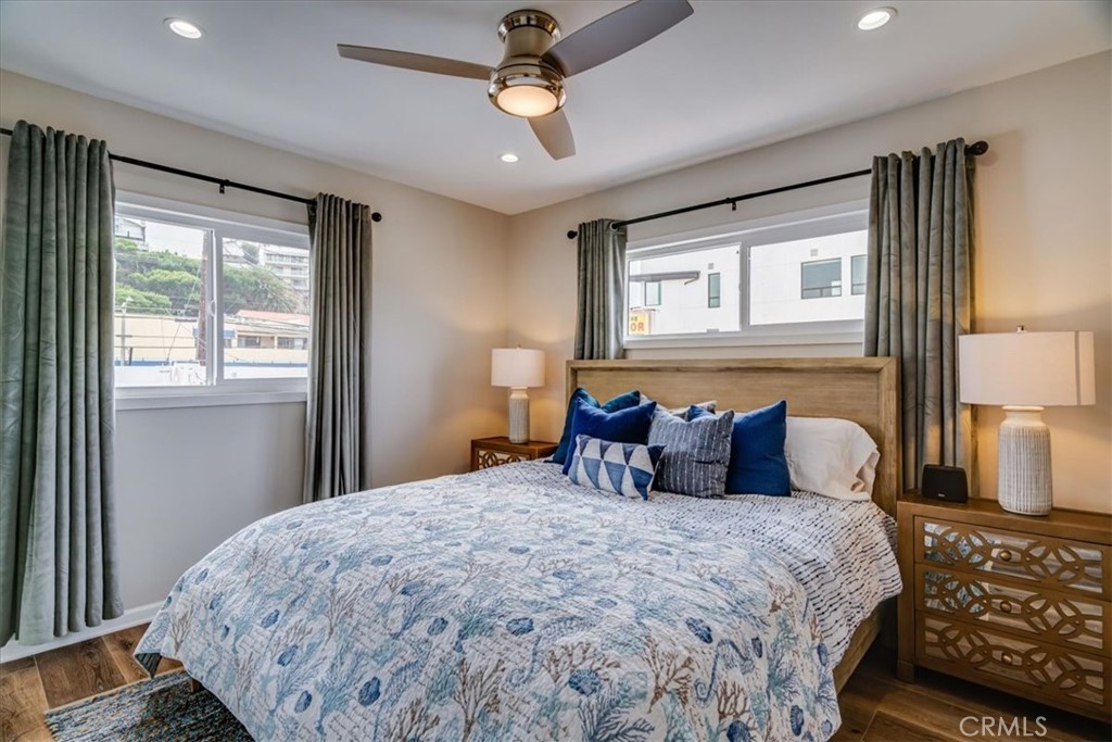 323 Culver Boulevard Playa del Rey, CA 90293 - Photo 55 of 58 a bedroom with a large bed and a chandelier