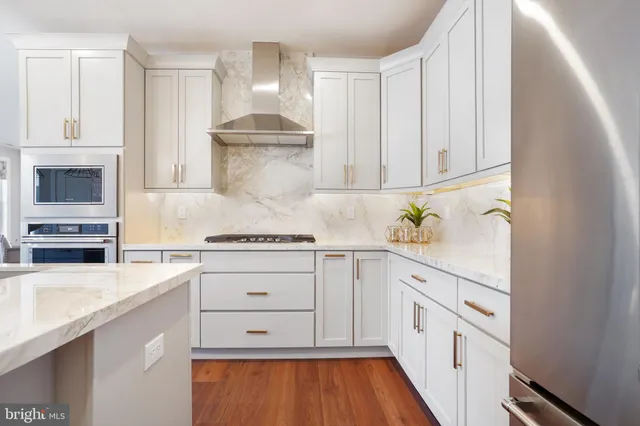 a kitchen with white cabinets and white appliances