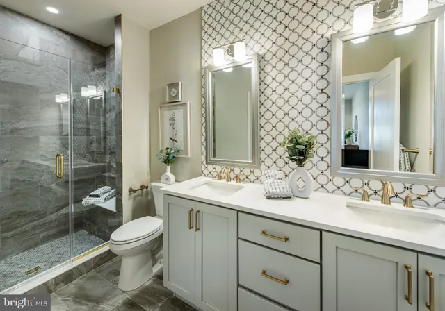 a bathroom with a sink toilet and shower