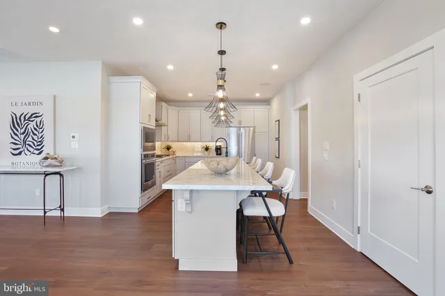 a view of a kitchen area with furniture and wooden floor