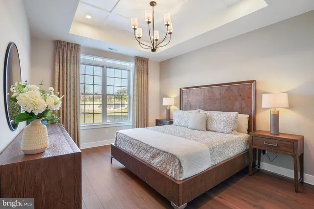 a bedroom with a bed table and a window