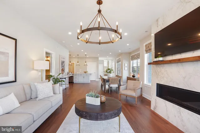 a living room with furniture a rug and a chandelier