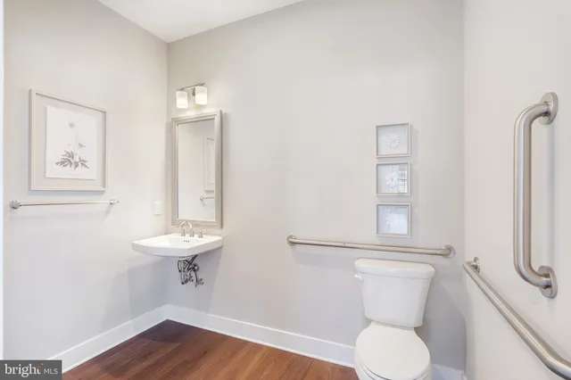 a white toilet sitting next to a bathroom sink