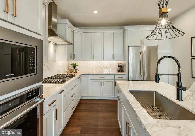 a kitchen with a sink stove and refrigerator