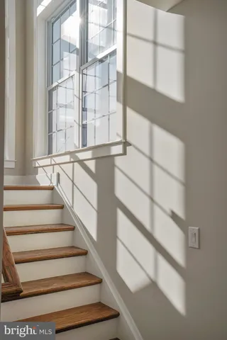 a view of staircase with white walls and a window