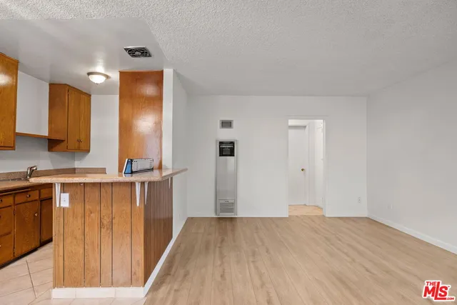 a view of a kitchen from the hallway