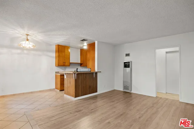 a view of a kitchen with wooden floor and a sink