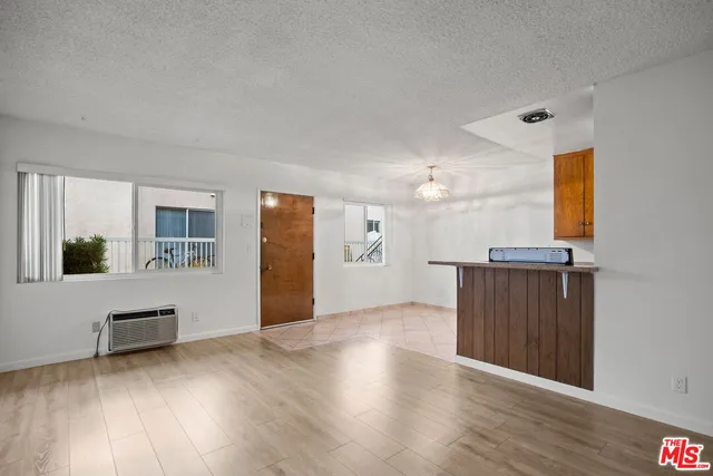 a view of a livingroom with wooden floor and a cabinet