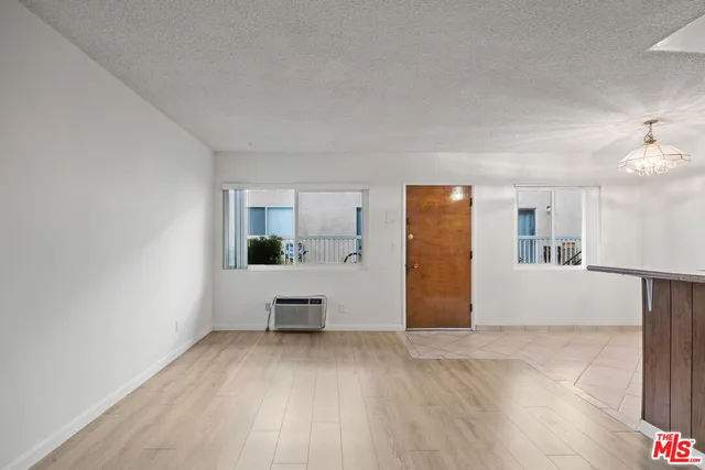 a view of kitchen with furniture and wooden floor