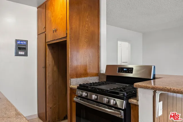 a kitchen with a stove and a refrigerator