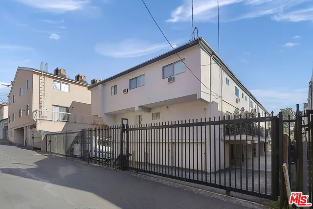 a view of a house with iron fence