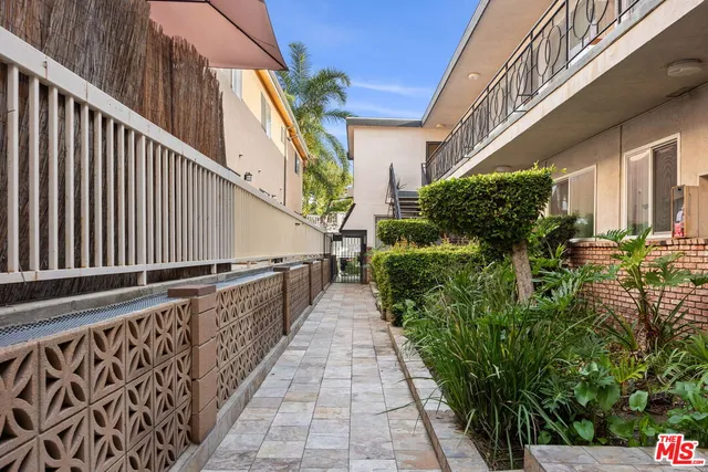 a view of balcony with lots of potted plants