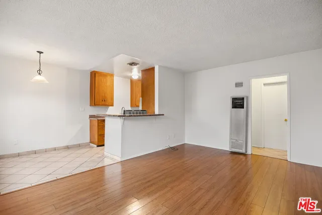 a view of a kitchen with wooden floor and cabinet