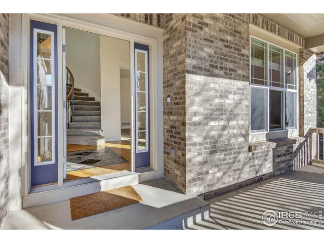a bathroom with a granite countertop sink a mirror and a shower