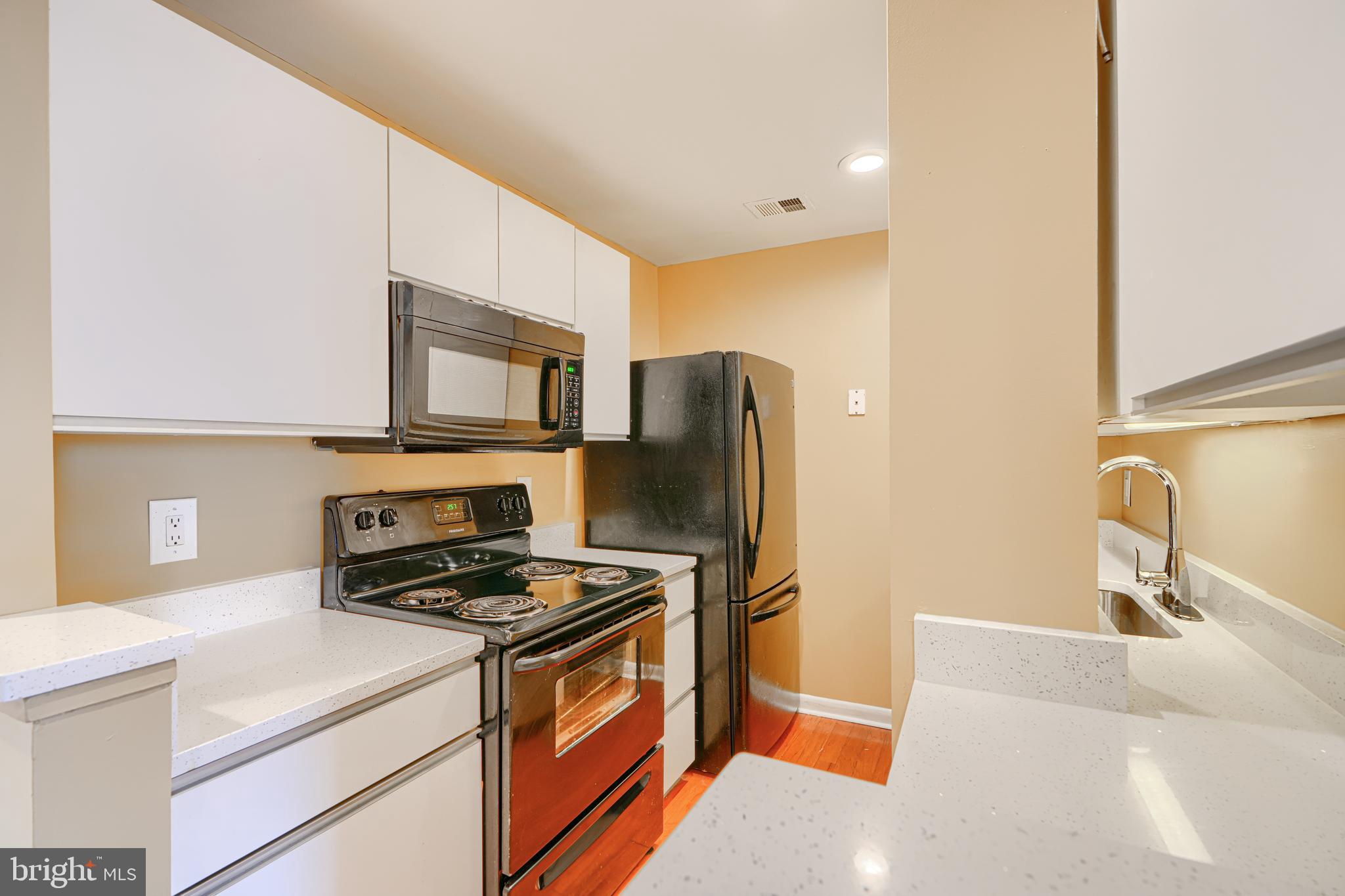2639 Boston Street, Unit 305 Baltimore, MD 21224 - Photo 12 of 21 a kitchen with stainless steel appliances a refrigerator stove and sink
