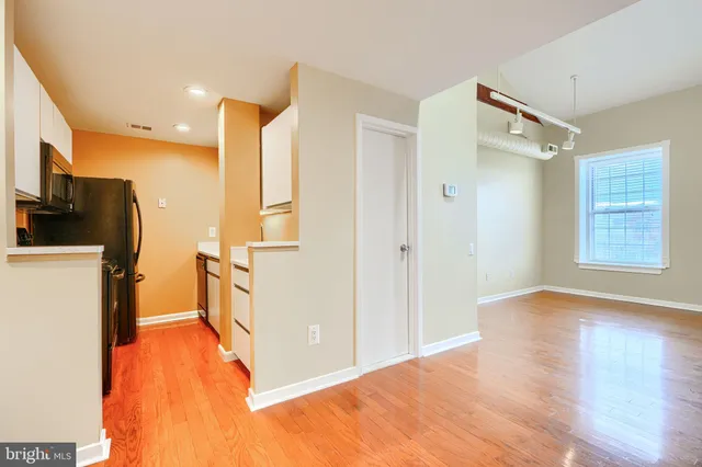 a view of a kitchen with a sink and a refrigerator