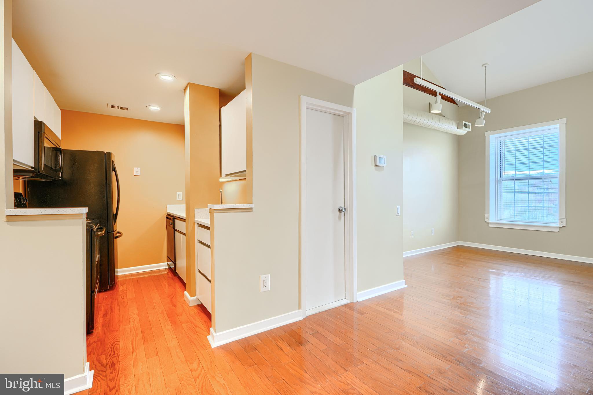 2639 Boston Street, Unit 305 Baltimore, MD 21224 - Photo 5 of 21 a view of a kitchen with a sink and a refrigerator