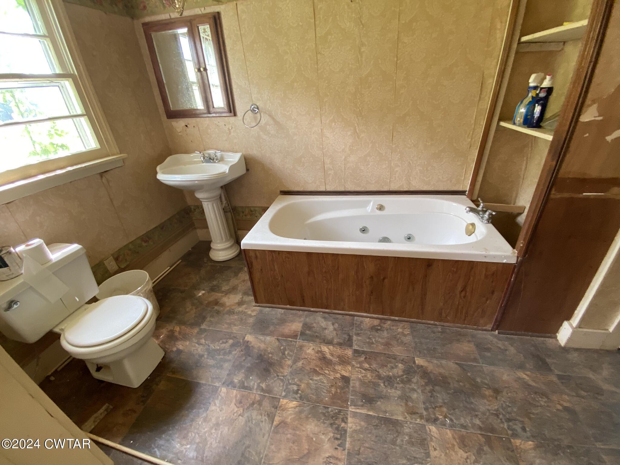 2160 Jones Road Luray, TN 38352 - Photo 7 of 8 a bathroom with a sink toilet and window