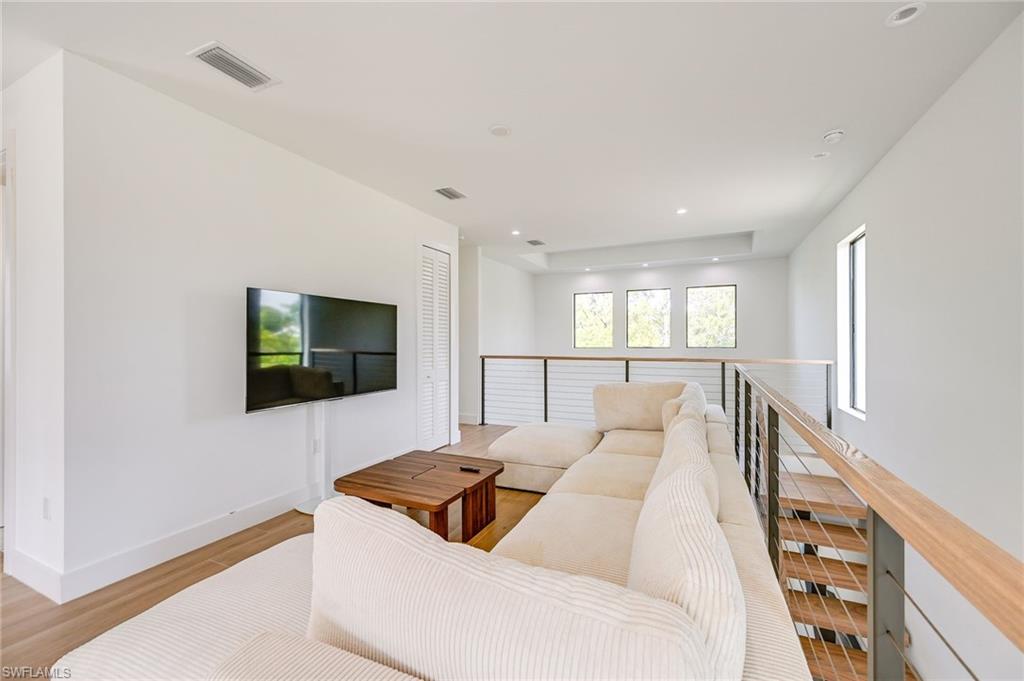 3384 Canal Street Naples, FL 34112 - Photo 18 of 34 Living room with light wood-style flooring and recessed lighting