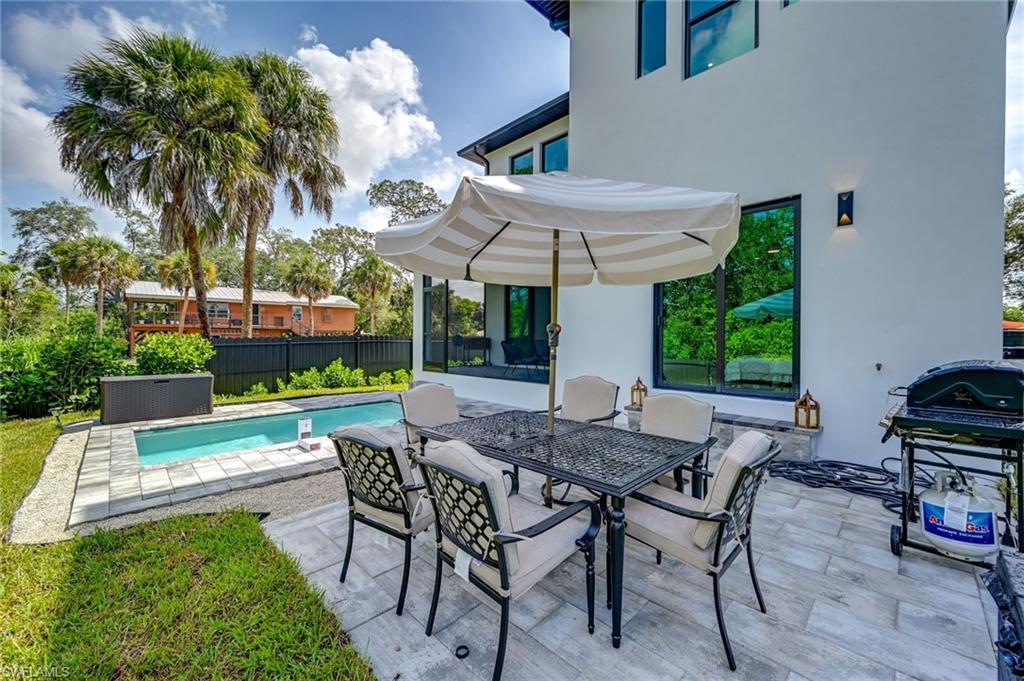 3384 Canal Street Naples, FL 34112 - Photo 30 of 34 View of patio featuring grilling area and outdoor dining area