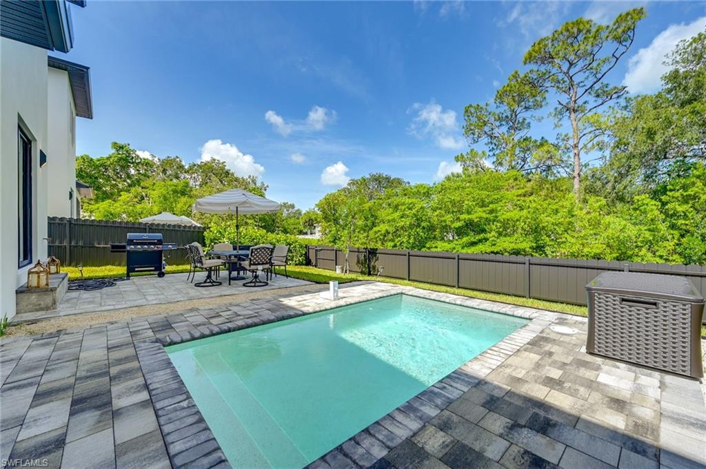3384 Canal Street Naples, FL 34112 - Photo 3 of 34 View of pool with a patio, a fenced backyard, and grilling area