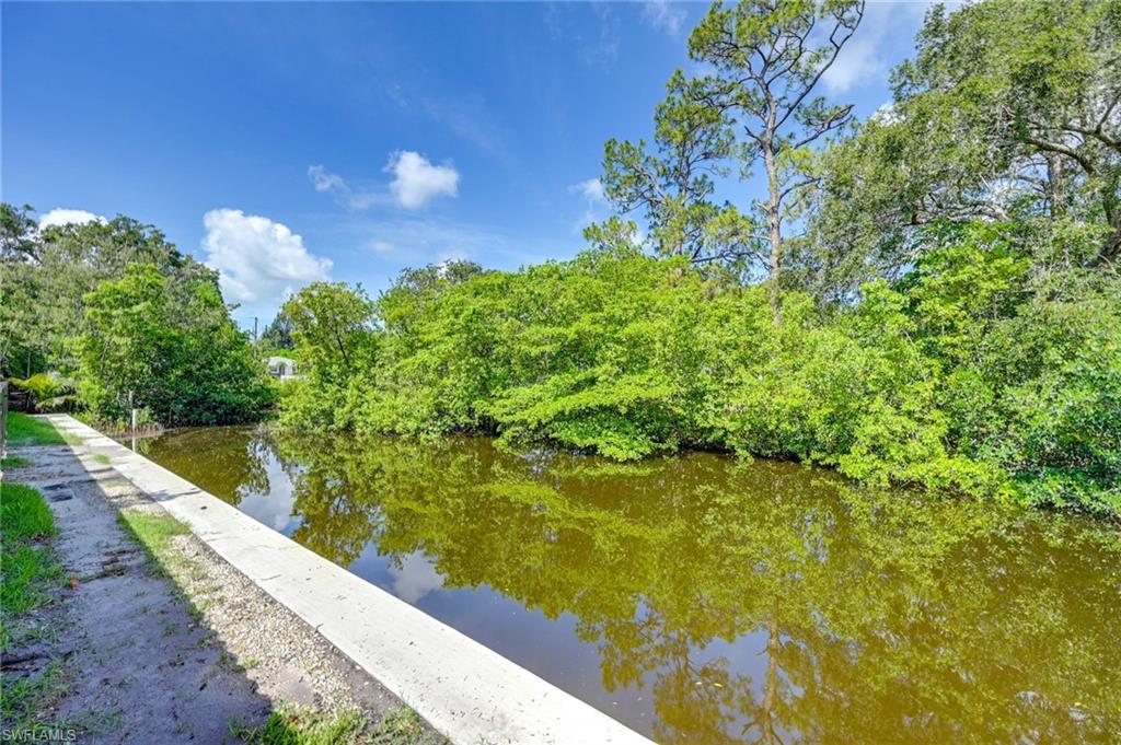 3384 Canal Street Naples, FL 34112 - Photo 32 of 34 Water view featuring a tree filled landscape