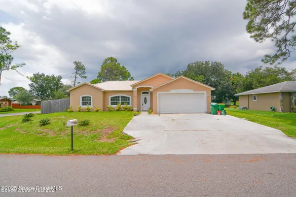 a front view of house with yard and green space