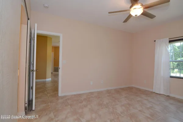 a view of a livingroom with a chandelier fan